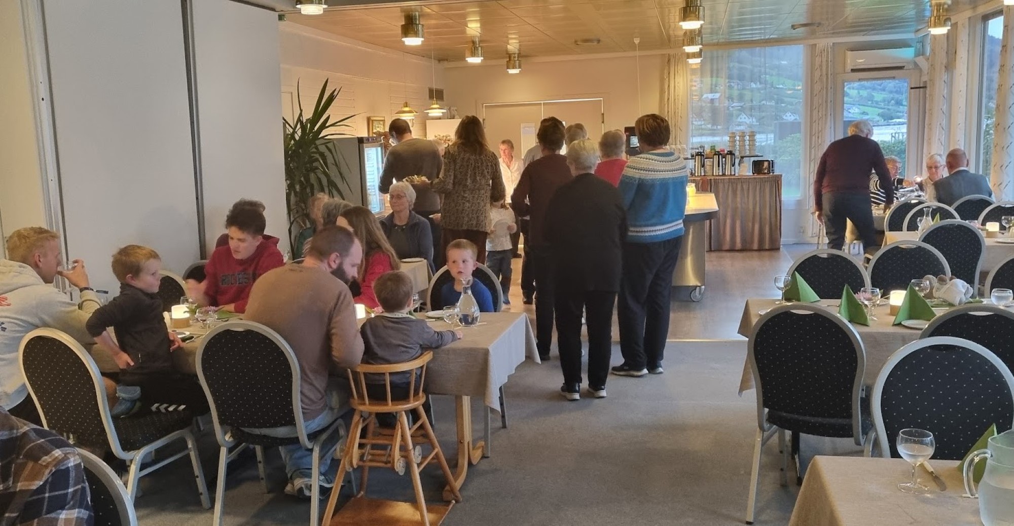 Folk sit ved bord og et