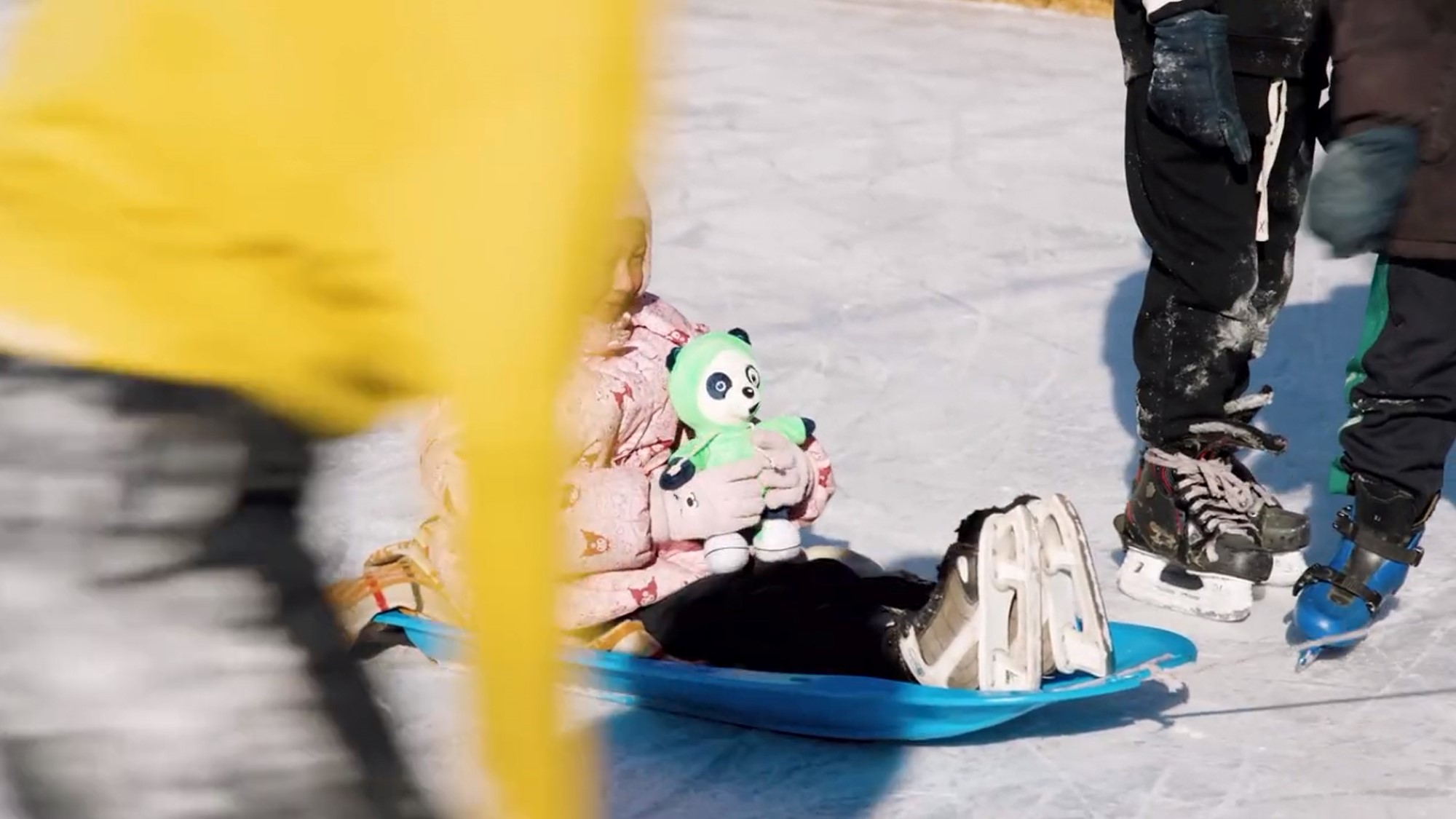 Skjermdump fra film, jente på akebrett holder Tellus-bamse